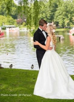 Bride and groom embracing at a scenic waterside venue